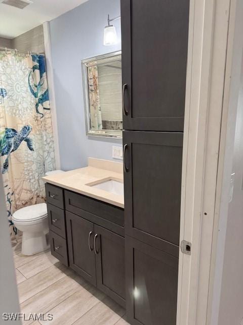 bathroom with vanity, a shower with curtain, and toilet