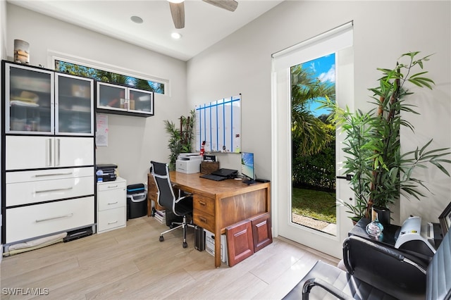 home office with ceiling fan and light hardwood / wood-style floors