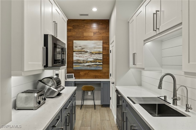 kitchen featuring light stone countertops and white cabinets