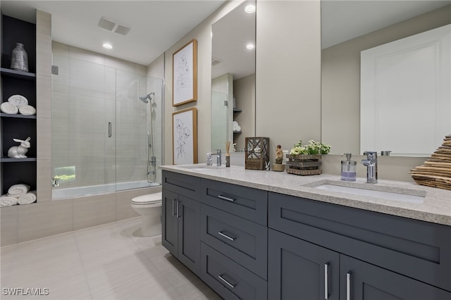 full bathroom featuring vanity, tile patterned floors, enclosed tub / shower combo, and toilet