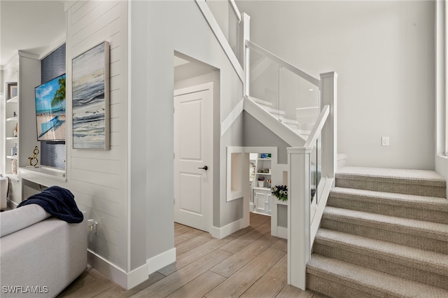 stairway featuring wood-type flooring