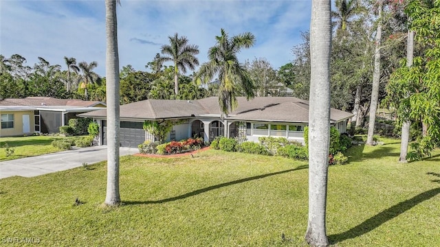 single story home featuring a garage and a front yard