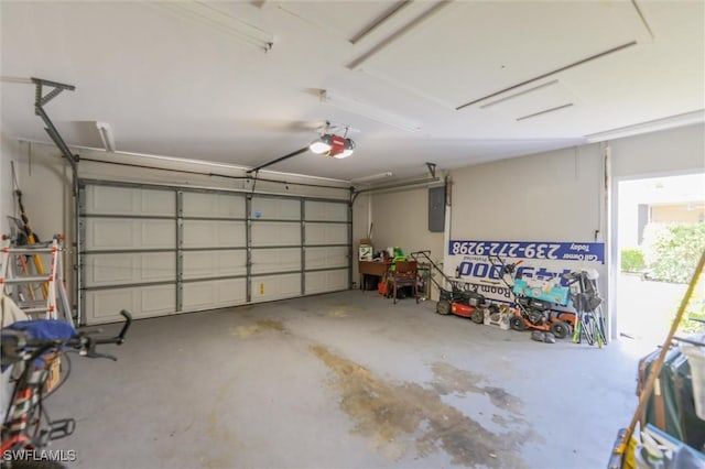 garage with a garage door opener and electric panel