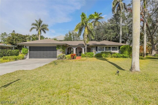 single story home featuring a garage and a front lawn