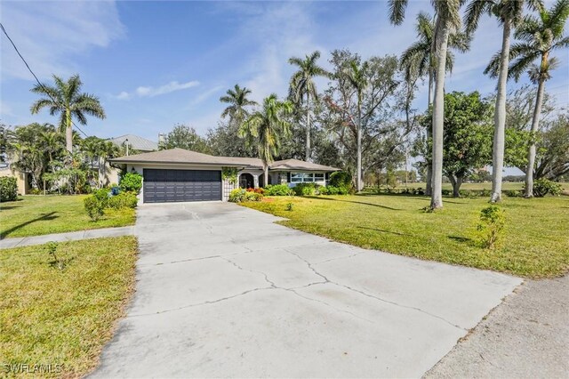 ranch-style home with a garage and a front yard