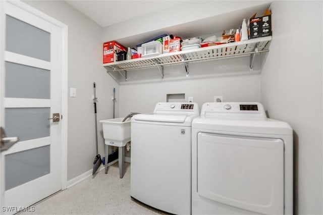 clothes washing area featuring washer and clothes dryer