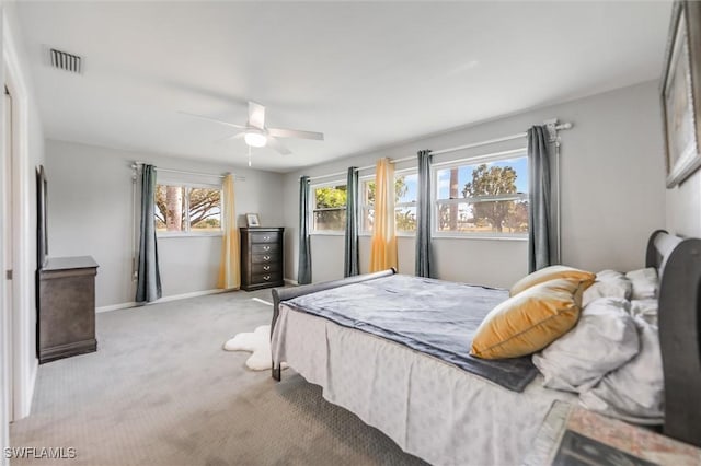 bedroom featuring ceiling fan and light carpet