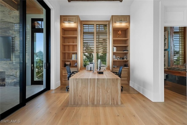 dining space featuring built in shelves and light wood-type flooring