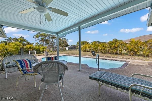 view of pool featuring ceiling fan and a patio