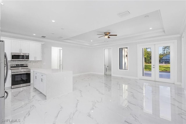 4091 56th Ave NE, Naples, FL 34120 - kitchen with appliances with stainless steel finishes, a raised ceiling, open floor plan, crown molding, and recessed lighting