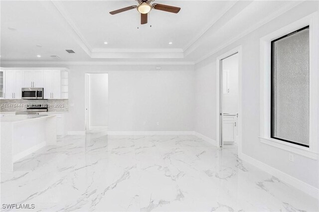 4091 56th Ave NE, Naples, FL 34120 - unfurnished living room with ceiling fan, a tray ceiling, light marble finish floors, baseboards, and ornamental molding