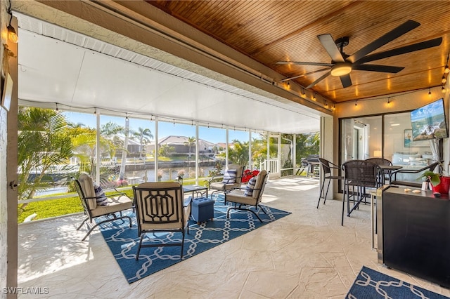 sunroom / solarium with wooden ceiling and ceiling fan