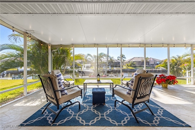 sunroom / solarium with a water view and a healthy amount of sunlight