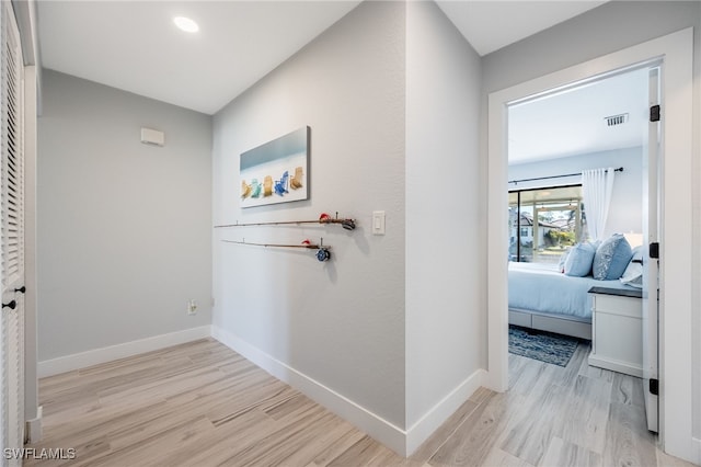 corridor featuring light hardwood / wood-style floors