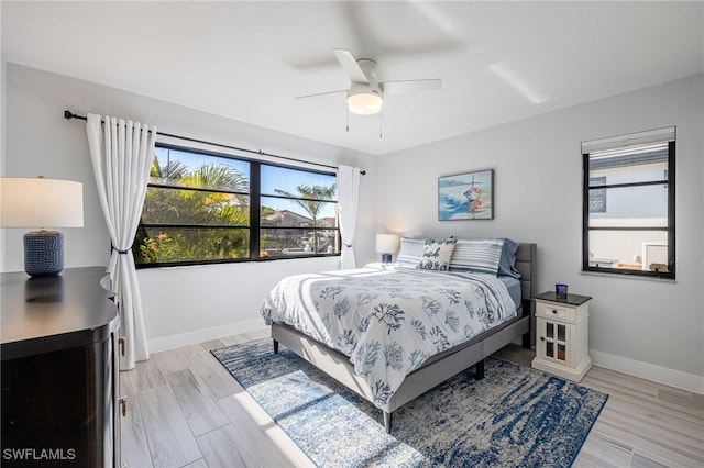 bedroom with light wood-type flooring and ceiling fan