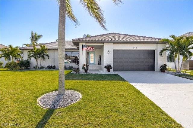 mediterranean / spanish home with a garage and a front lawn