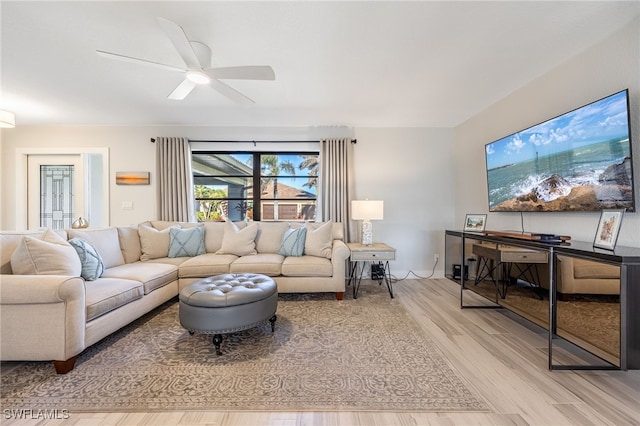 living room with light hardwood / wood-style floors and ceiling fan