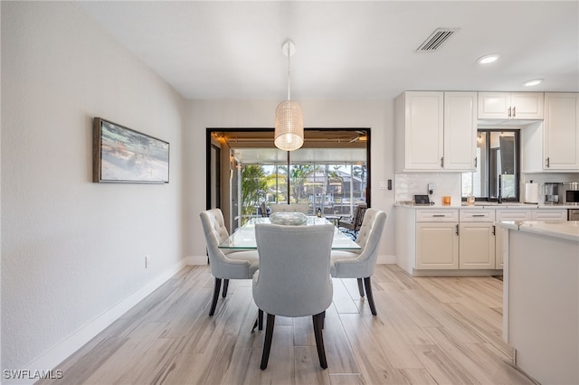 dining area with light hardwood / wood-style floors