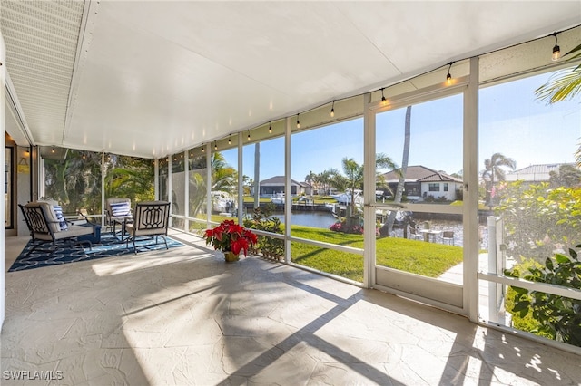 unfurnished sunroom with a water view and a wealth of natural light