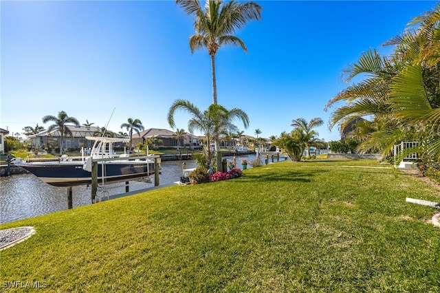 view of yard featuring a dock and a water view