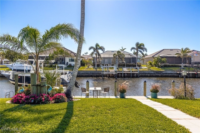 dock area with a yard and a water view