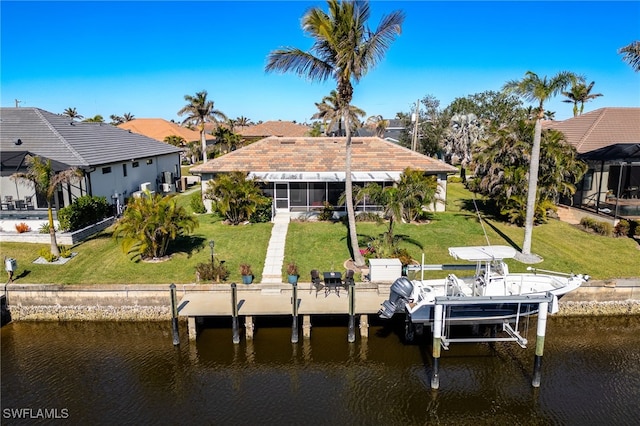 view of dock featuring a lawn and a water view