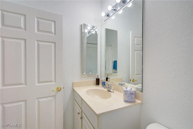 13911 Lake Mahogany Blvd Unit 2922, Fort Myers, FL 33907 - bathroom featuring vanity, a textured wall, and toilet