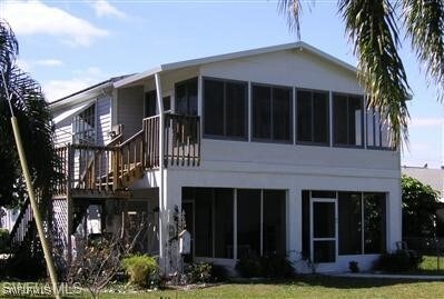 rear view of house with a lawn