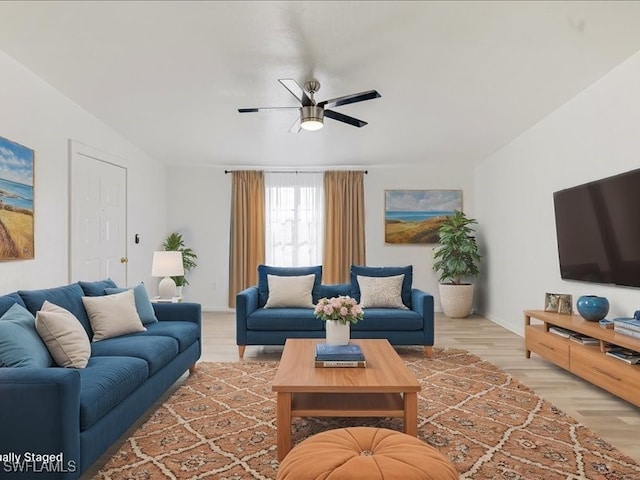 living room with ceiling fan and light hardwood / wood-style floors