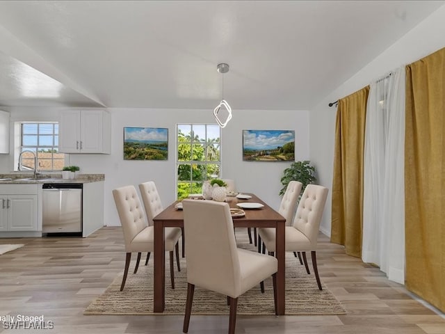 dining space with a healthy amount of sunlight, light hardwood / wood-style floors, and sink