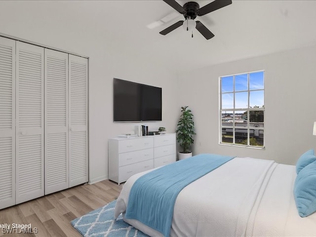 bedroom with ceiling fan, a closet, and light wood-type flooring