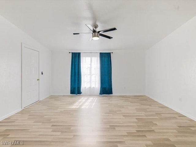 empty room featuring light hardwood / wood-style flooring and ceiling fan