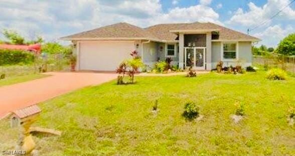 view of front of home with a garage and a front lawn