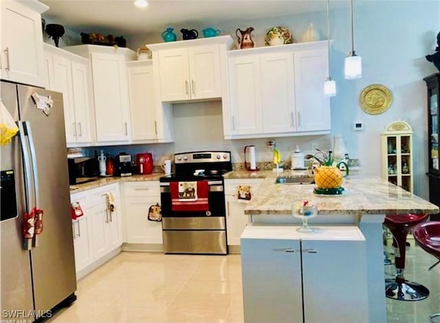 kitchen featuring white cabinetry, appliances with stainless steel finishes, and pendant lighting