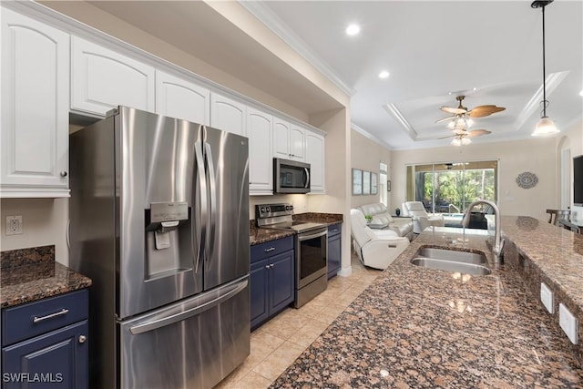 10696 Camarelle Cir, Fort Myers, FL 33913 - kitchen featuring stainless steel appliances, a sink, open floor plan, white cabinetry, and ornamental molding