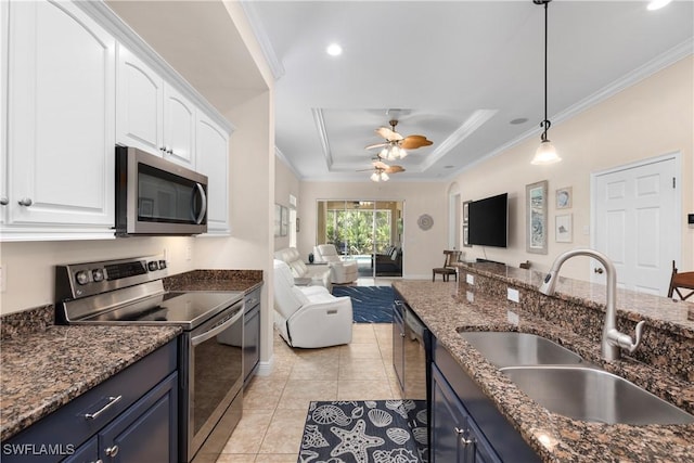 10696 Camarelle Cir, Fort Myers, FL 33913 - kitchen with stainless steel appliances, a sink, open floor plan, crown molding, and white cabinetry