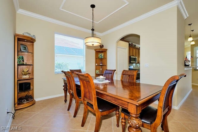 tiled dining area featuring crown molding