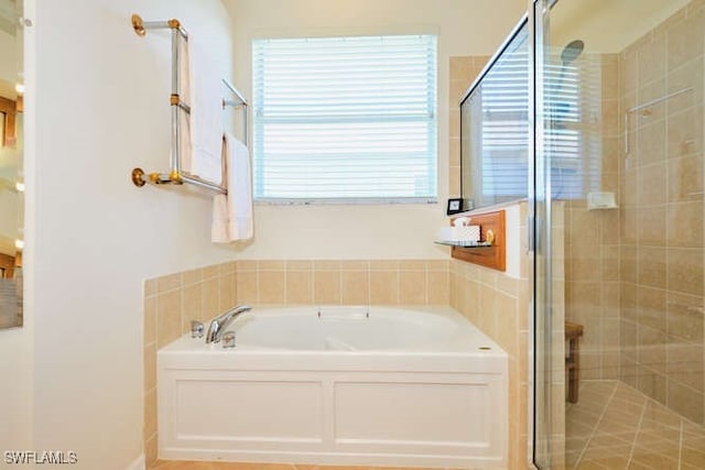 bathroom featuring independent shower and bath