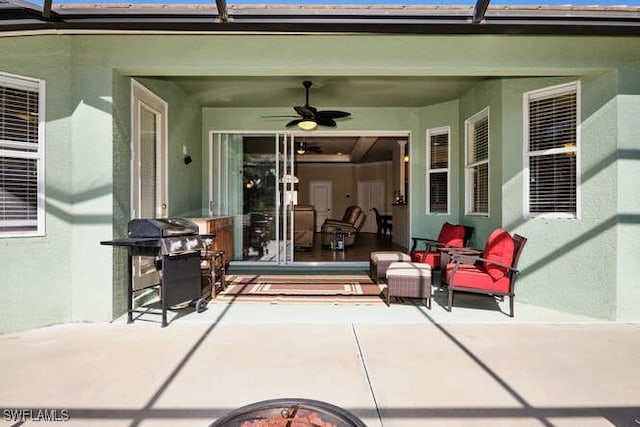 view of patio featuring area for grilling, a lanai, and ceiling fan