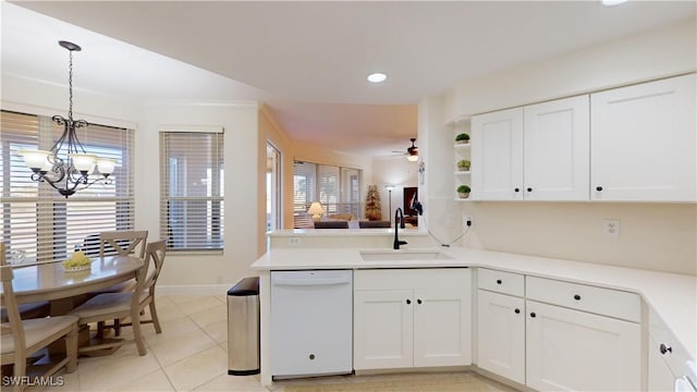 kitchen with sink, white cabinets, hanging light fixtures, white dishwasher, and kitchen peninsula