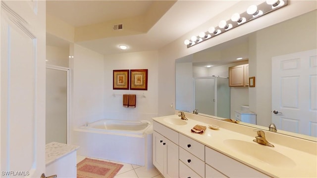 bathroom with tile patterned flooring, vanity, and independent shower and bath