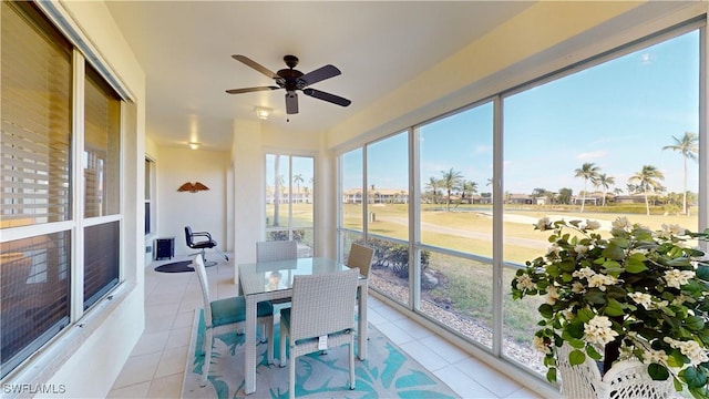 sunroom featuring ceiling fan and a healthy amount of sunlight