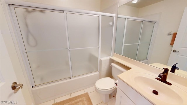 full bathroom featuring tile patterned flooring, vanity, shower / bath combination with glass door, and toilet