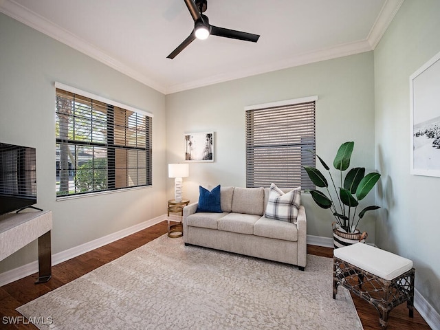 living room featuring hardwood / wood-style flooring, crown molding, and ceiling fan