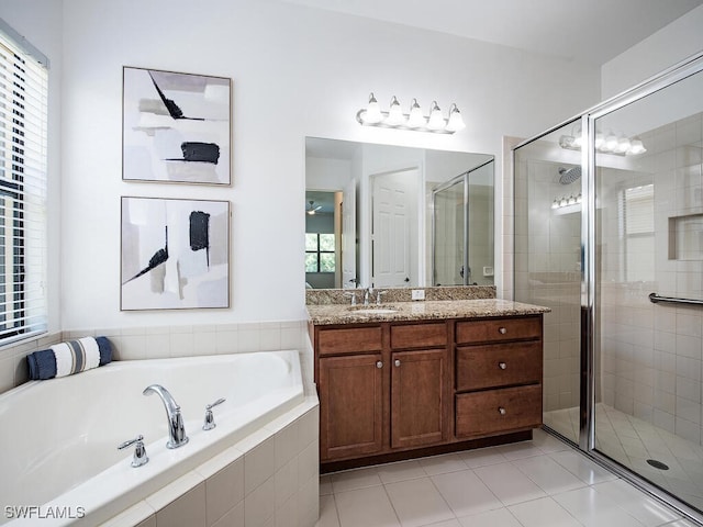 bathroom with tile patterned flooring, vanity, and independent shower and bath