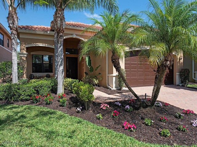 mediterranean / spanish house with a garage