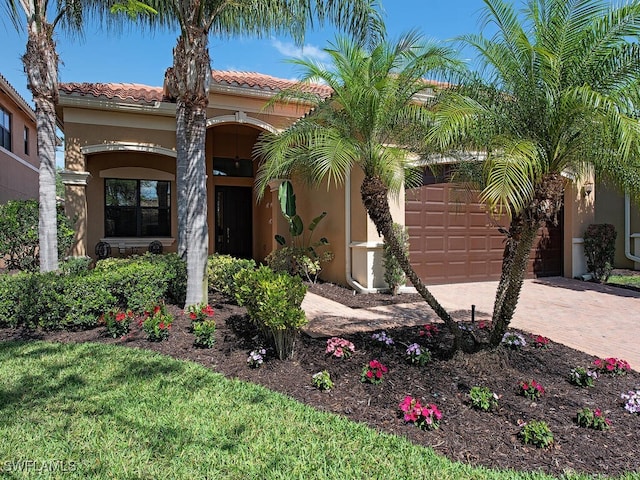 mediterranean / spanish home with a garage