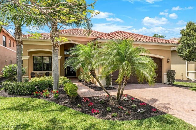 mediterranean / spanish home featuring a garage