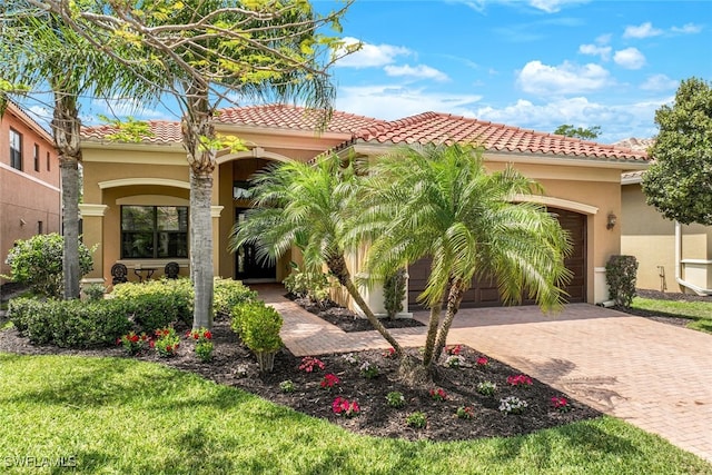 mediterranean / spanish-style home with a garage