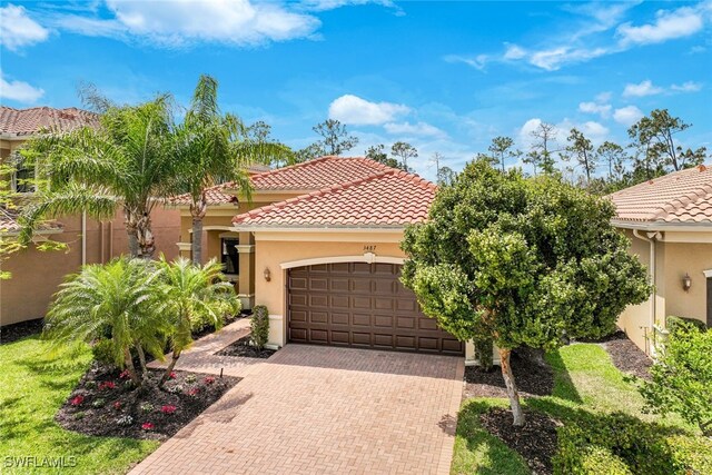 mediterranean / spanish-style home with a garage